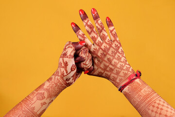 Beautiful henna or mehendi decoration on a hindu bride's hand & Feet | Isolated hand & feet with...