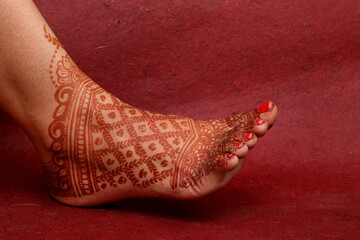 Beautiful henna or mehendi decoration on a hindu bride's hand & Feet | Isolated hand & feet with...