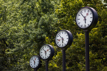 Classic black and white analog clocks with synchronized time show teamwork and synced project...