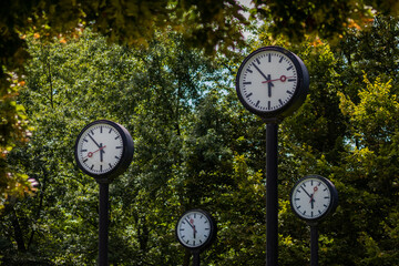 Classic black and white analog clocks with synchronized time show teamwork and synced project...