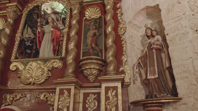 Panning shot of holy sculpture and statue in Church of Saint Barbara,Santo Domingo