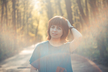 a girl in the sun in the forest