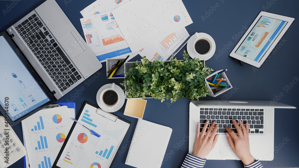Poster top view of businesswoman working at financial company graphs on computer in corporate startup offic