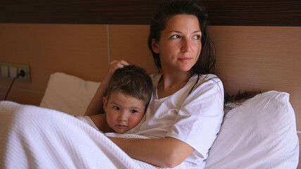 Fototapeta premium Mom relaxing with her little son
