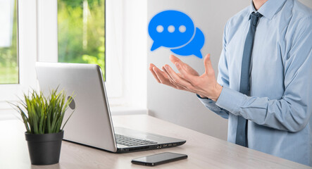 Businessman holding a message icon, bubble talk notification sign in his hands. Chat icon, sms icon, comments icon, speech bubbles