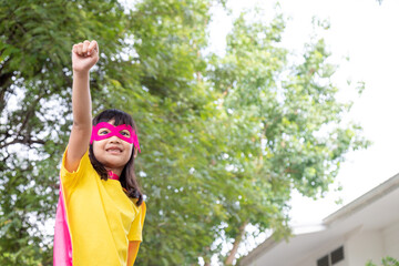 Little child girl plays superhero. Child on the white background. Girl power concept © FAMILY STOCK