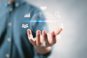 Businessman holding Global network connection. World map point and line composition concept of global business. Big data analytics and business intelligence concept.