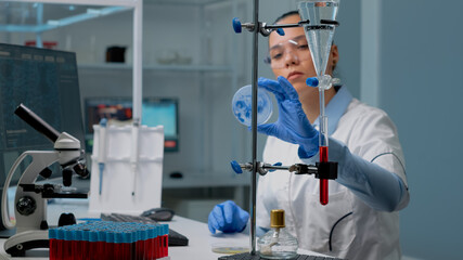 Microbiology woman studying petri dish in laboratory at clinic, having chemical equipment. Doctor...