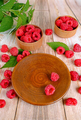 Wooden background with raspberries.