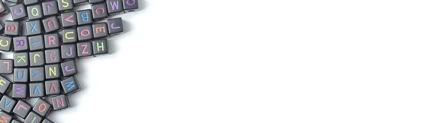 A lot of small cubes with letters on a white background. Copy Space.