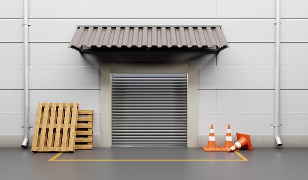 Gate warehouse with metal rolling shutter. Building front store or factory with wooden pallets and traffic cones on street. Storehouse with automatic door, yellow line road marking and awning on wall