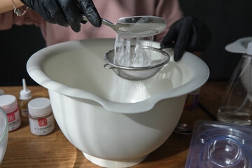 handmade bath bombs process. Preparation of bath bombs. Ingredients and floral decor on a wooden...