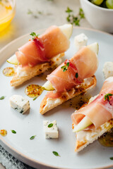 chic appetizer with pear and prosciutto