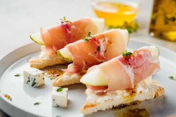 chic appetizer with pear and prosciutto