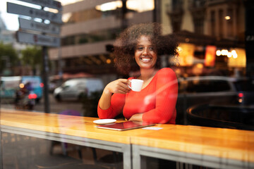 Fototapeta na wymiar Young woman at cafe drinking coffee. Beautiful woman enjoying in fresh coffee