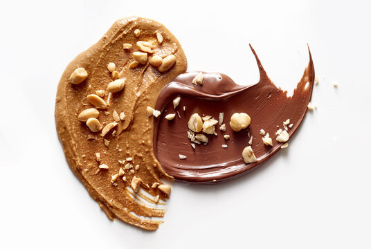 Peanut butter and chocolate paste on white background