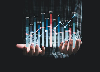 Businessman hand draw growth graph and business growth and progress of business and financial  ,business planning and strategy on back background.