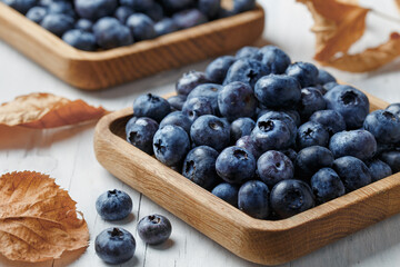 Blueberry or bilberry, fresh berry on wood background