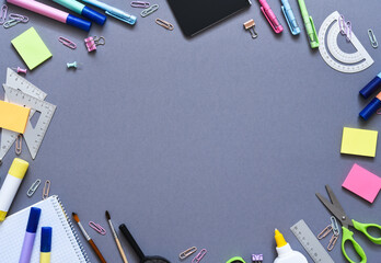 Back to school. School supplies: notebook, pen, pencil on a gray background. View from above....