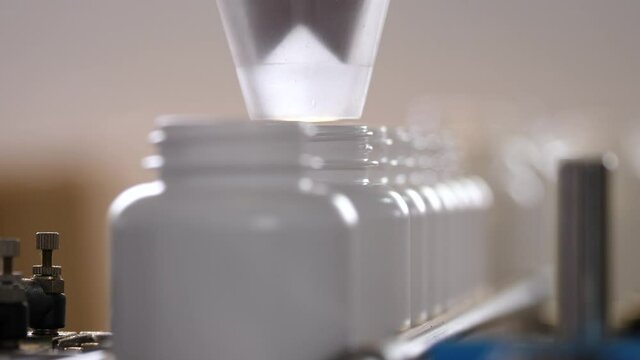 Pharmaceutical production. Medical capsules are moving in a packaging machine.