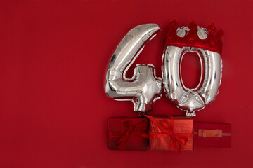 Silver Number Balloons 40 forty in crown on dark red background. Holiday Party Decoration, 40 postcard concept with top view - obrazy, fototapety, plakaty