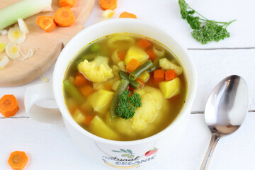 Homemade vegetable soup with cauliflower, potatoes, and beans. Healthy, dietary meals