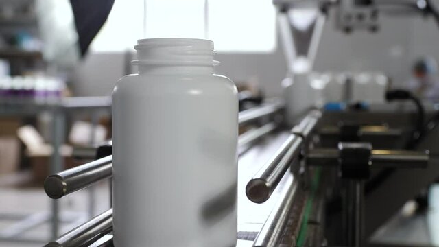 Pharmaceutical production. Medical capsules are moving in a packaging machine.