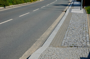 better safety, the cities are equipped with posts on the edge of the sidewalk with chain railing. direct pedestrians to cross the road safely. the blind have protrusions on the tiles for tactile feet
