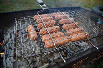 delicious fried sausages on the fire