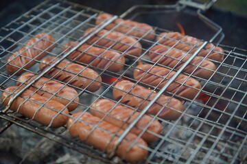delicious fried sausages on the fire