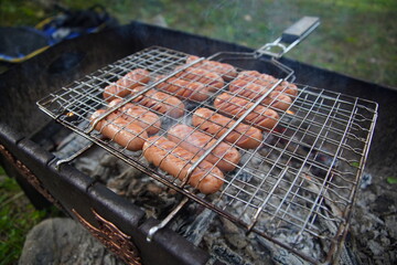 delicious fried sausages on the fire