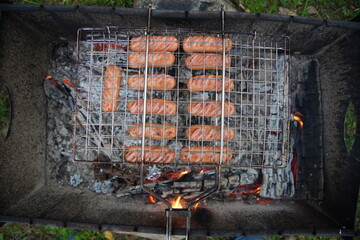 delicious fried sausages on the fire