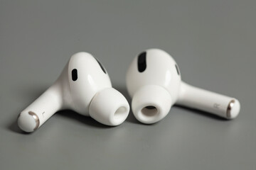 Wireless earphones on grey background