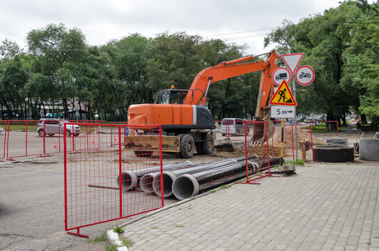 Excavator. Heavy machinery during road repairs. Replacement of sewer pipes