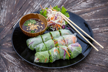 Fresh vietnamese spring rolls on a plate with salad