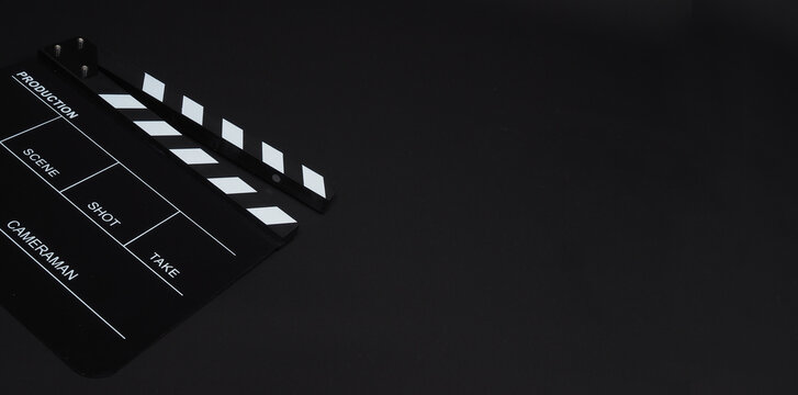 Clapperboard or clap board or movie slate use in video production ,film, cinema industry on black background.