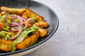 Closeup view of fried potato wedges with champignons