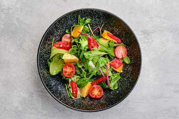Top view of spicy salad with orange, chilli, tomato, cucumber and avocado