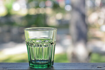 Empty glass cup on a blurry background of a street cafe