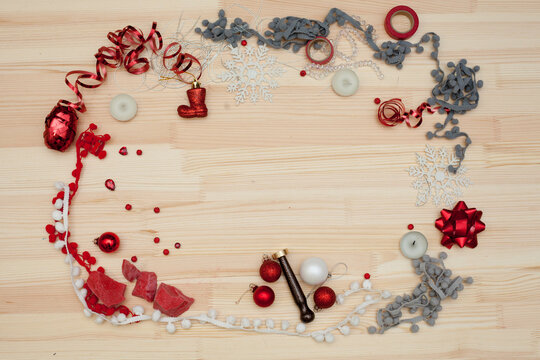 christmas decorations on a wooden background, a frame of christmas decorations and ribbons, preparation for the new year and christmas
