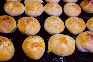 Homemade traditional  pastries on baking tray. Traditional Russian pastries Vatrushka.Round and appetizing homemade pies baked  with a nice tan color