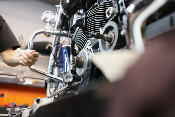 Repair and maintenance of motorcycle engines in car workshop closeup