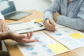 Two business leaders talk about charts, financial graphs showing results are analyzing and calculating planning strategies, business success building processes