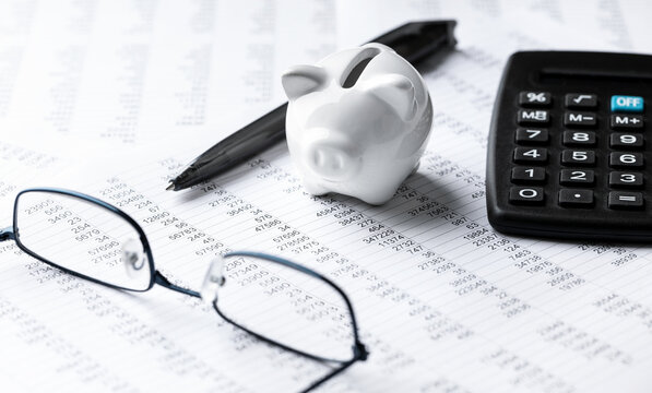 Finance And Business Concept - Pen, Calculator & Piggy Bank