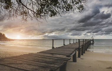 Sea wooden bridge and raining clouds.