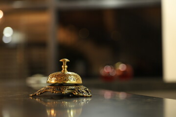 Bell on wood for service with blurred wooden background.