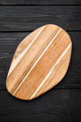 Cutting board, on black wooden table background, top view flat lay , with copy space for text or your product