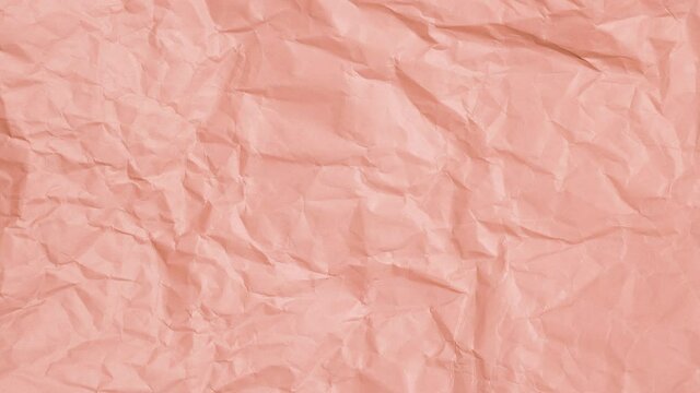 Looped Stop motion of Crumpled pastel pink paper texture background.