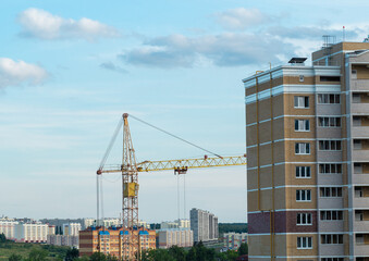 Fototapeta na wymiar View of a new residential neighborhood in the city of Cheboksary, on the area of private houses and a construction crane in the foreground.