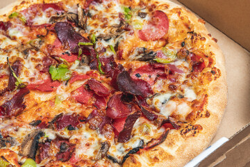 Top view of hot pizza in recycled pizza box.